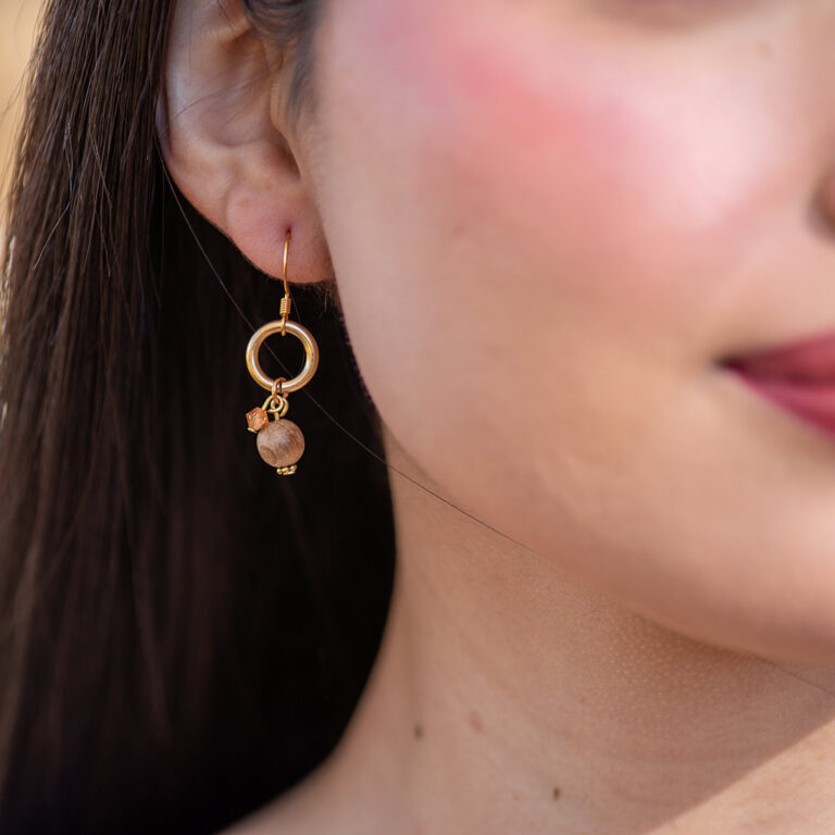 Handcrafted nanmuwood earrings featuring a natural, warm wood tone with intricate details, showcasing an elegant and sustainable accessory.